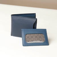Front of a Blue pebble leather Milano wallet with card case holder sitting on a beige background