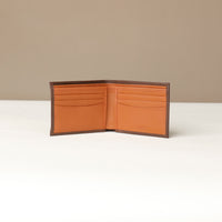 Front of a open brown pebble leather Milano wallet with orange inside and 9 visible slots