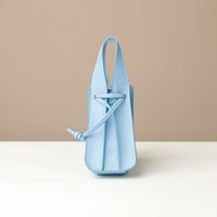 Light blue handbag on a beige background