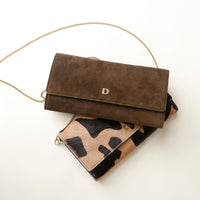 Brown suede Danilos clutch with gold chain and camouflage pattern on a white background
