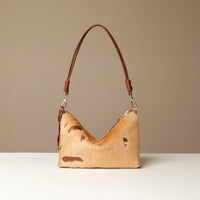crossbody Danilos bag made of animal skin with a brown handle on a beige background