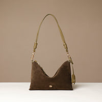 green Danilos handbag with a strap on a beige background
