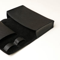 Close up view of a open black Danilos Pebble executive accessory holder linea on a beige background
