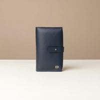 Front view of a marine blue Danilos Pebble executive accessory holder linea on a beige background