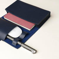 close up view of a open marine blue Danilos Pebble executive accessory holder linea on a beige background