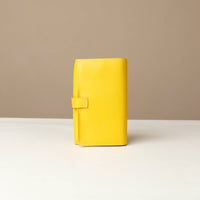 back view of a yellow Danilos Pebble executive accessory holder linea on a beige background