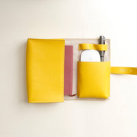 upper view of a yopen ellow Danilos Pebble executive accessory holder linea on a beige background