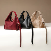 Three Danilos handbags in red, black, and beige on a white surface with a beige background