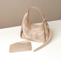 Beige Danilos handbag and pouch on a white surface with a beige background