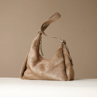 Beige Danilos handbag with a strap on a beige background