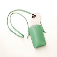 Green phone pouch with a phone inside on a white background