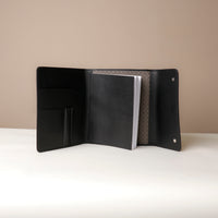 Open Danilos professional black leather portfolio with compartments