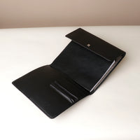 Open Danilos professional black leather portfolio with compartments