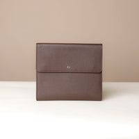 Brown leather envelope on a beige background