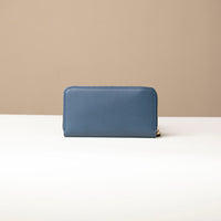back view of a blue Danilos wallet Carlota in a beige background
